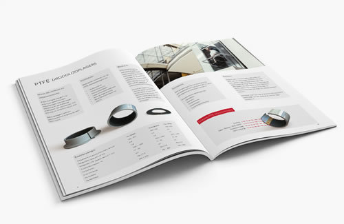 Aufgeschlagener Produktkatalog mit technischen Daten und Bildern zu PTFE-Gleitlagern