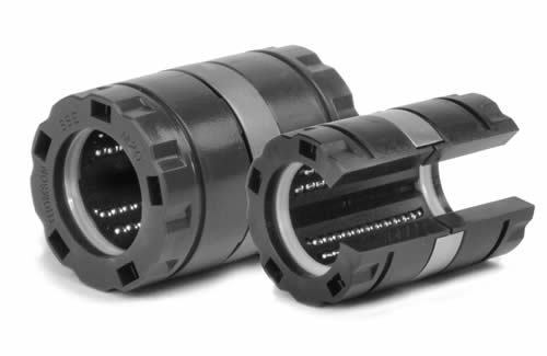 Two flanged linear ball bearings, one closed and one open, with polymer housing and visible ball tracks.