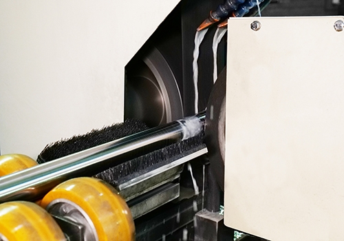 Slijpmachine in actie met koeling, wielen en borstel voor precisie-assen