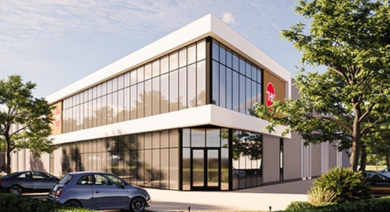 Nieuw bedrijfspand THN met moderne glasgevel en parkeerplaatsen